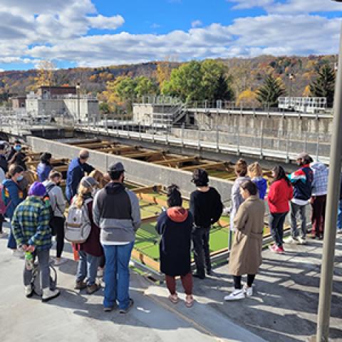 Group stands around a wastewater treatment plant