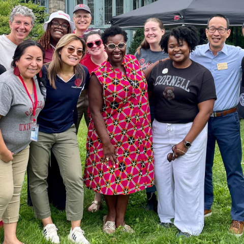 Staff members pose together outdoors.