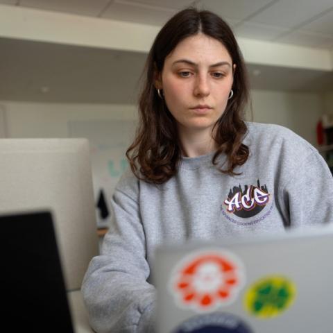 student works on a laptop computer