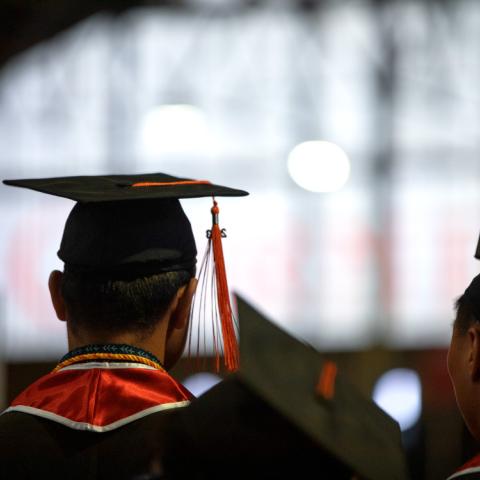 Graduates standing inside of Barton Hall