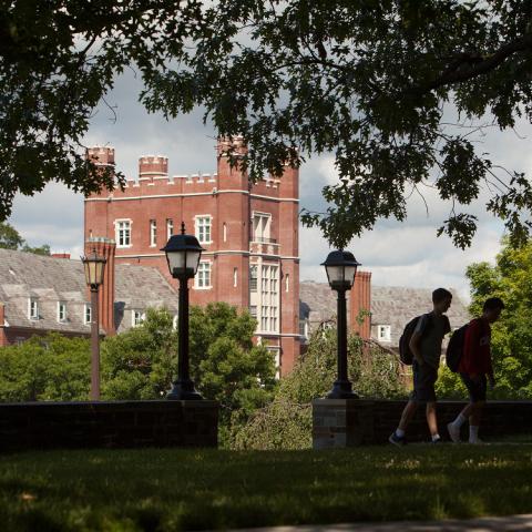 Photo of Risley Hall in summertime with two students walking by it