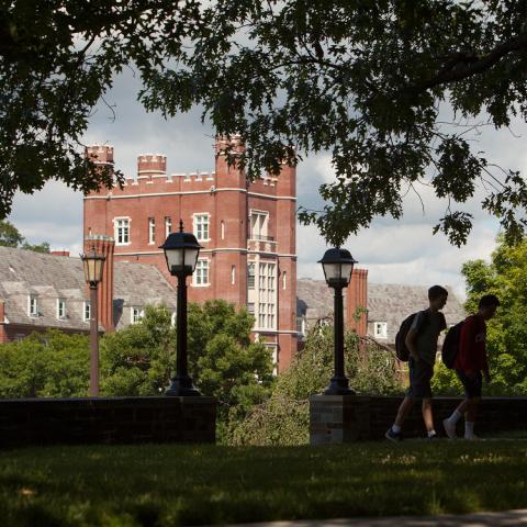 Photo of Risley Hall in summertime with two students walking by it