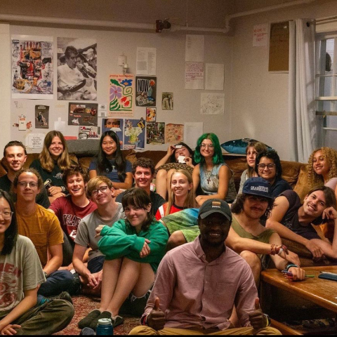 Triphammer residents sitting in the living room smiling and hanging out