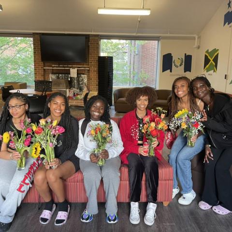 Photo of Ujamaa residents posing with flowers