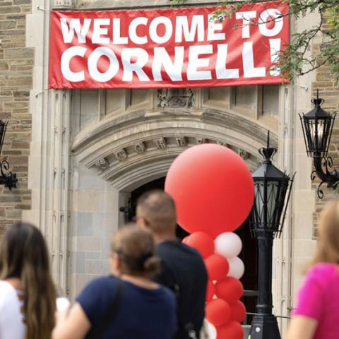Exterior photo of Willard Staight Hall with welcome signage for new students and families.