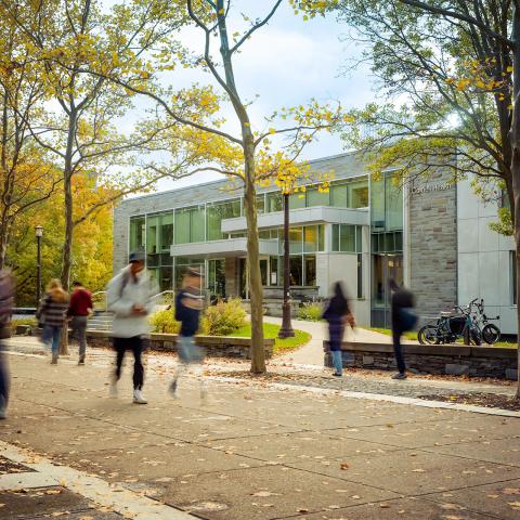 Photo of Ho Plaza with students walking in front of Cornell Health