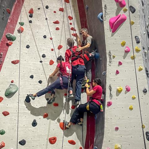 Students on the indoor adaptive ropes course