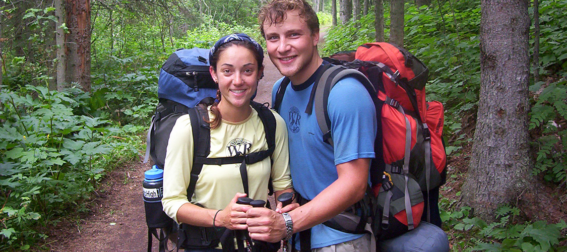 A couple backpacking on a trail