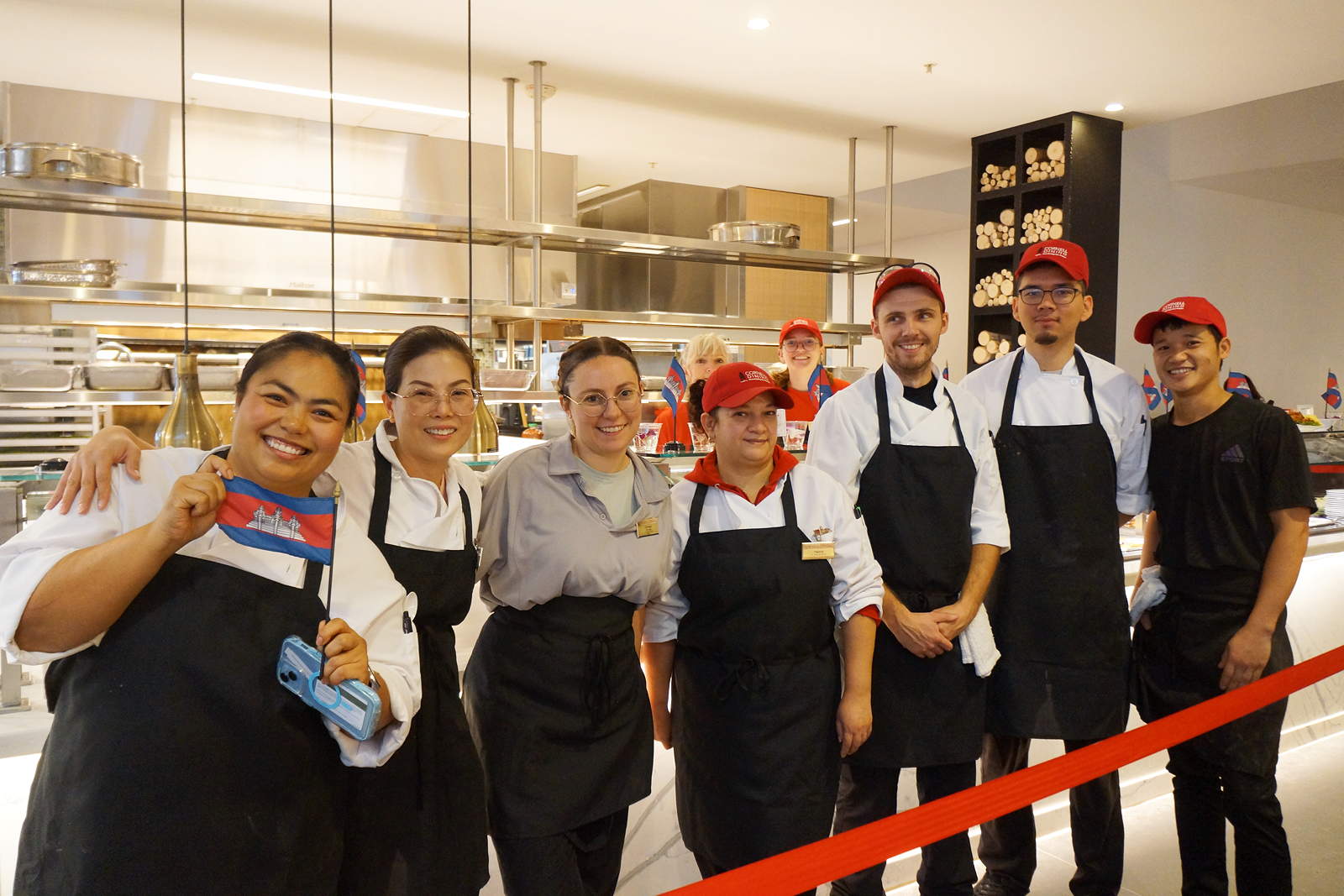 A row of culinary staff wearing aprons