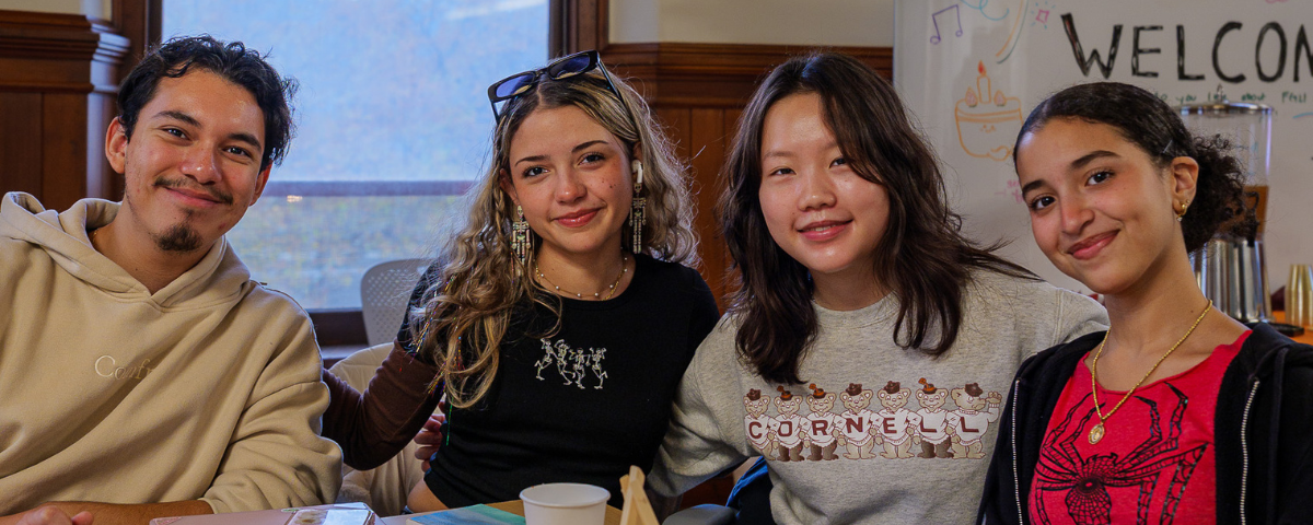 FOUR STUDENTS POSE IM BARNES HALL