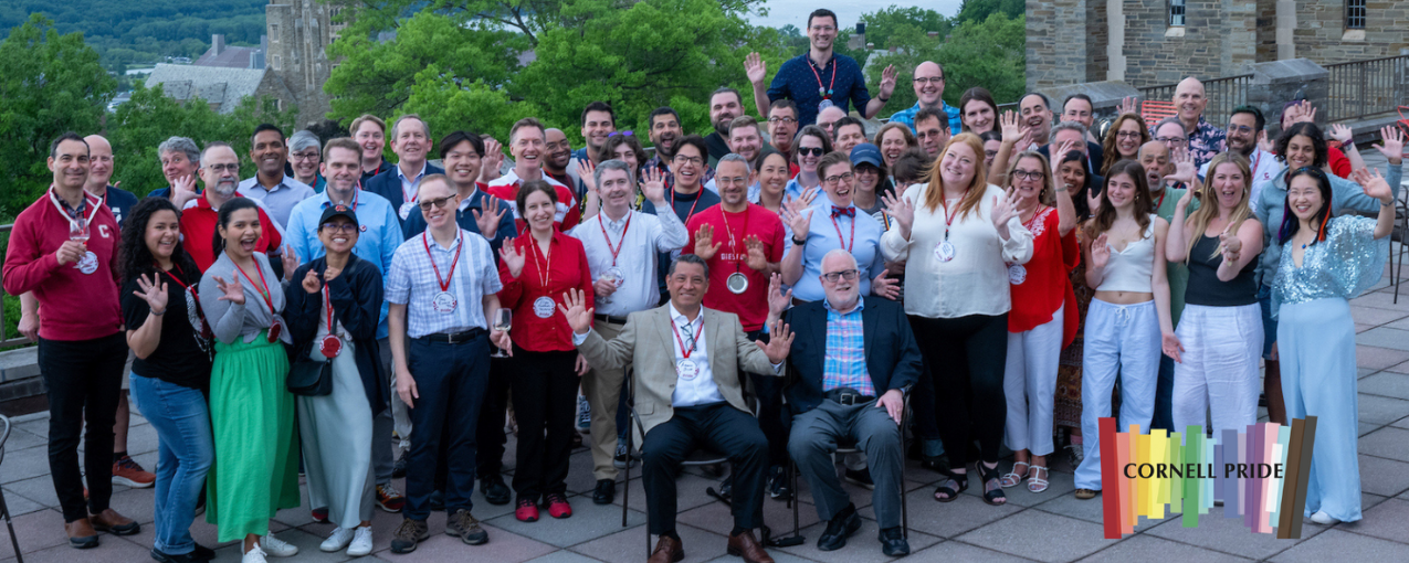 Large group of people stand at Cornell Reuin on an outdoor terrace. Photo reads "Cornell Pride."