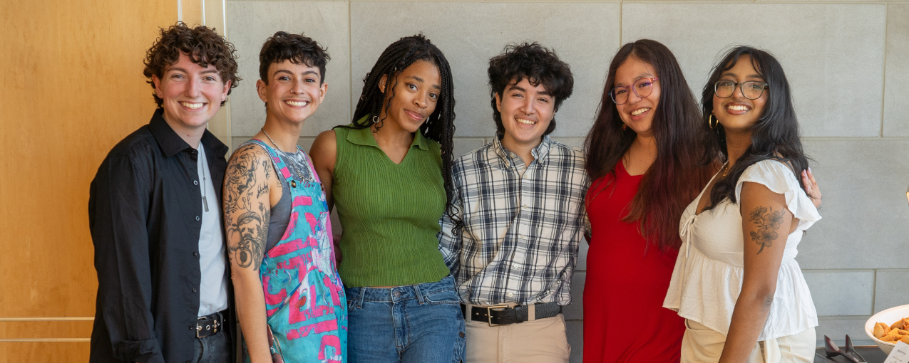 6 students stand arm in arm.