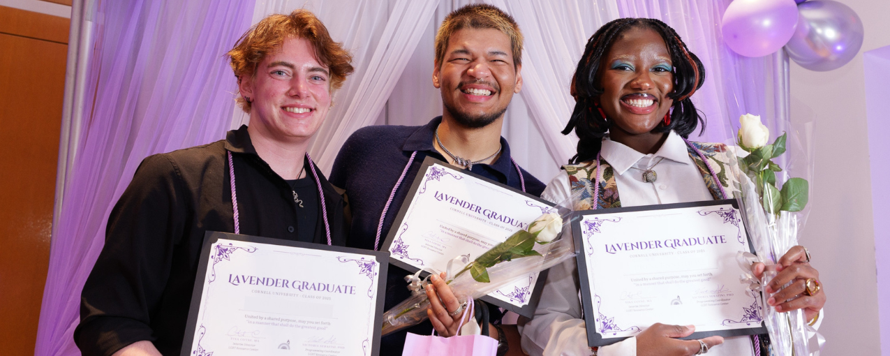3 students pose with "Lavender Graduate" certificates and flowers.