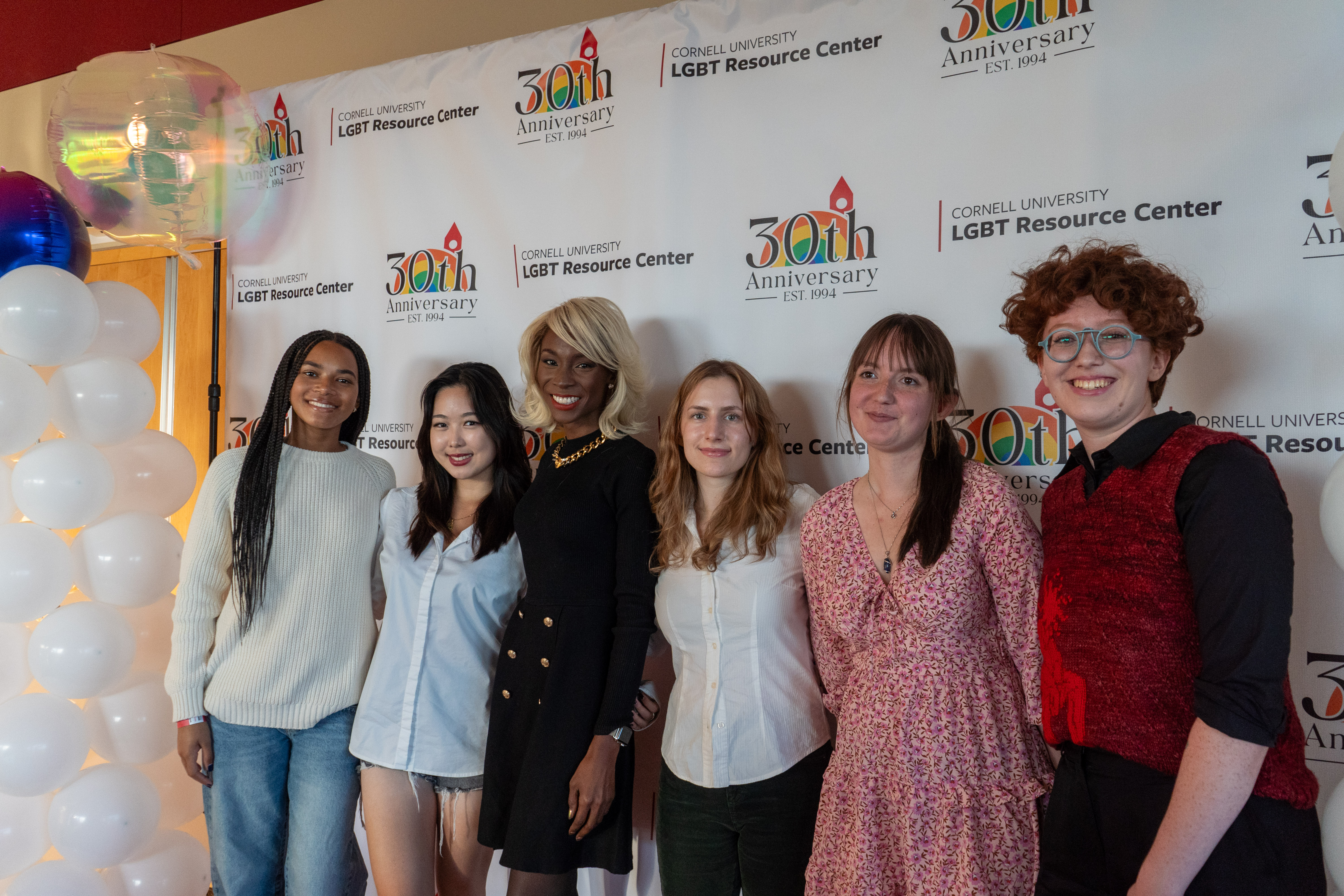 Students pose at a speaking event.