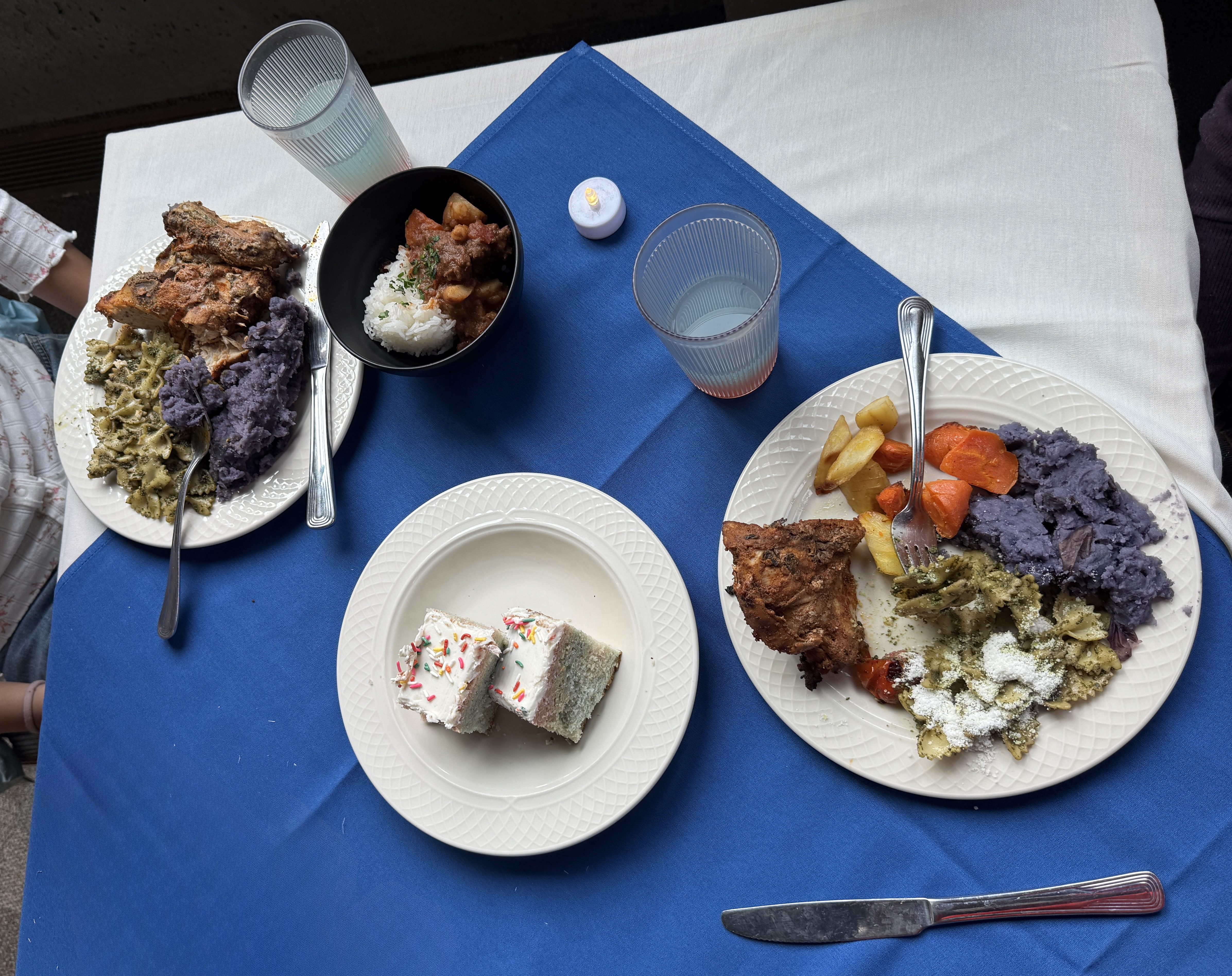 Plates of food on blue and white tablecloths