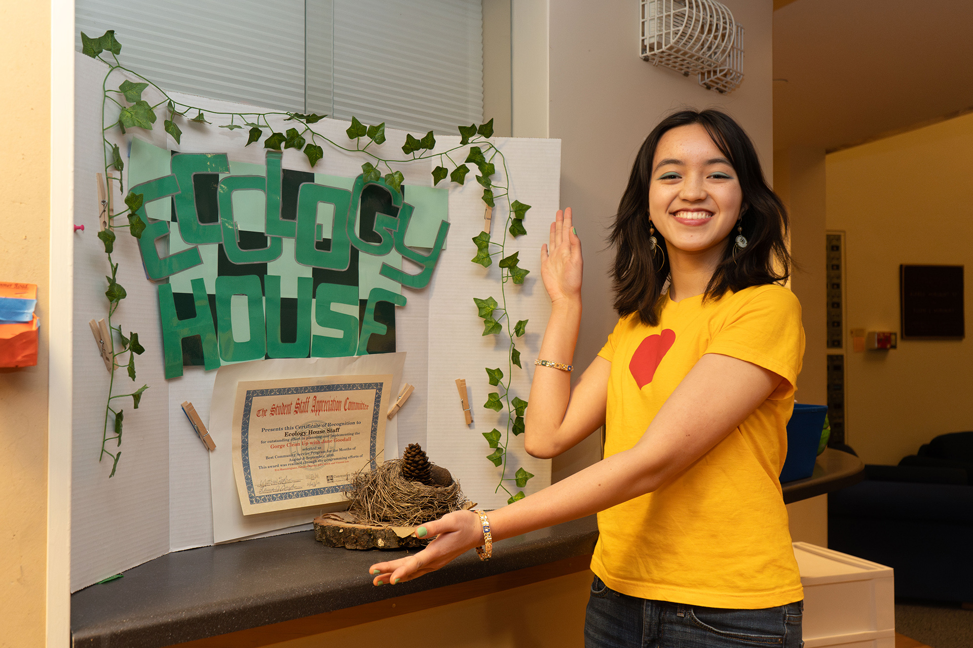 Resident stands in front of Ecology House presentation board