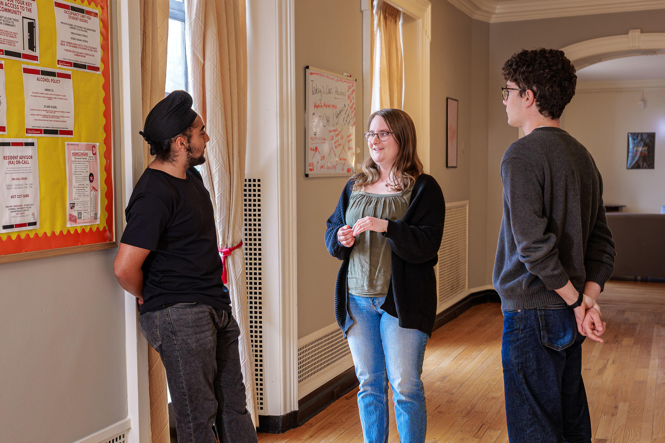 Students speak to each other in the hallway of the Equity, Engagement and Community house
