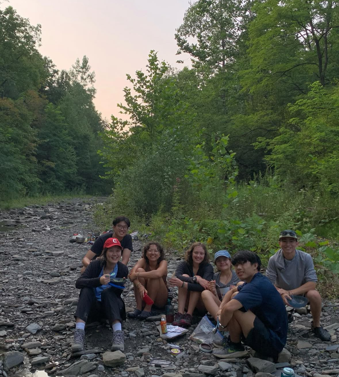 3 boys and 4 girls sitting in a dry creek bed