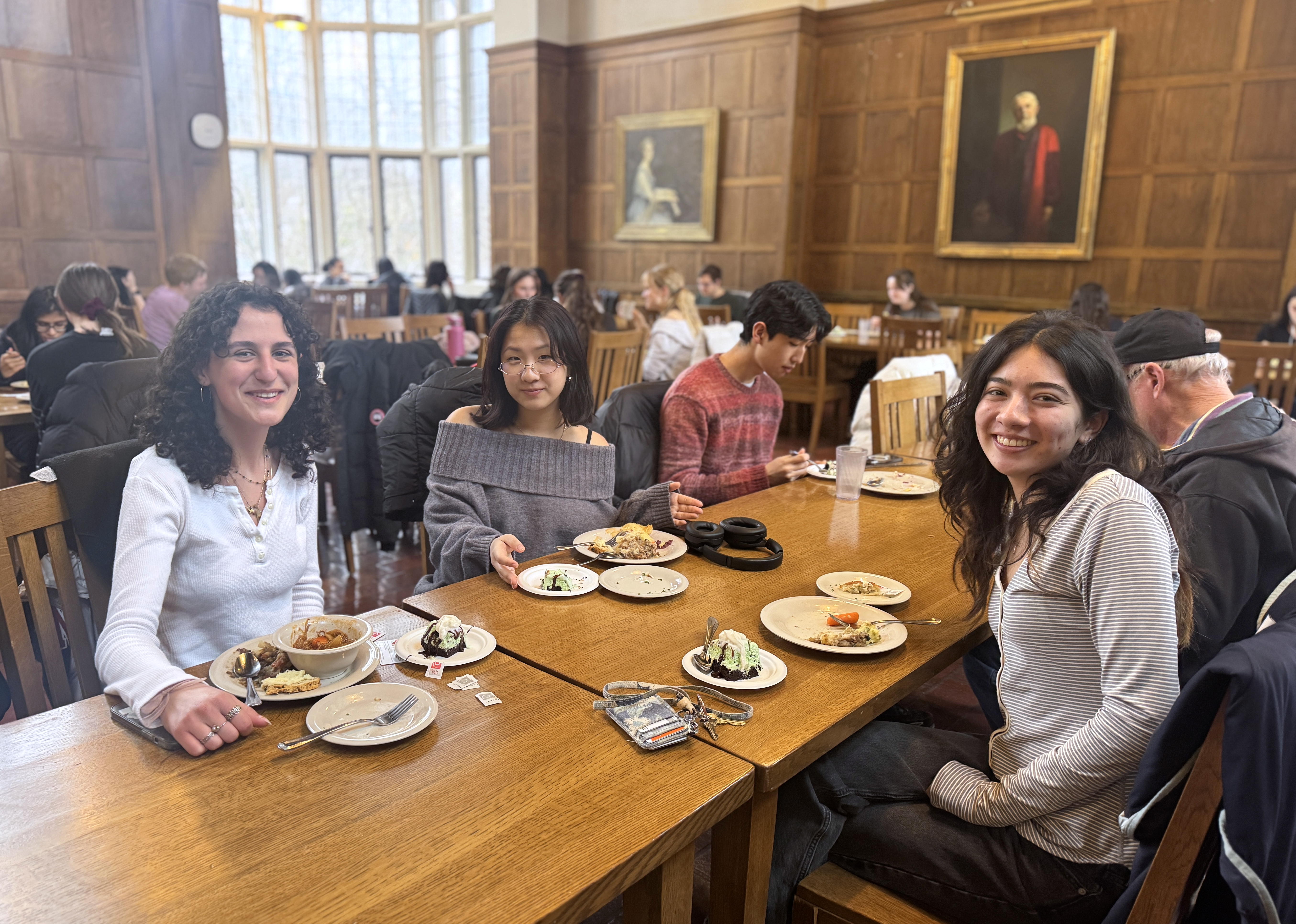 People sit around a table with plates of food