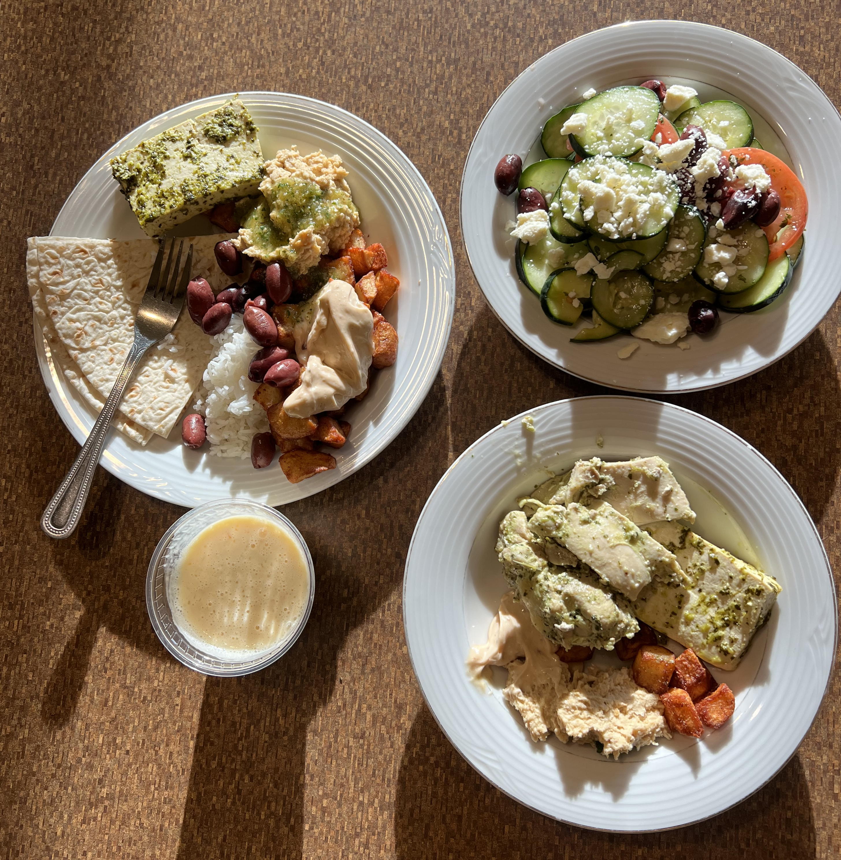 Three plates with assorted food on a table