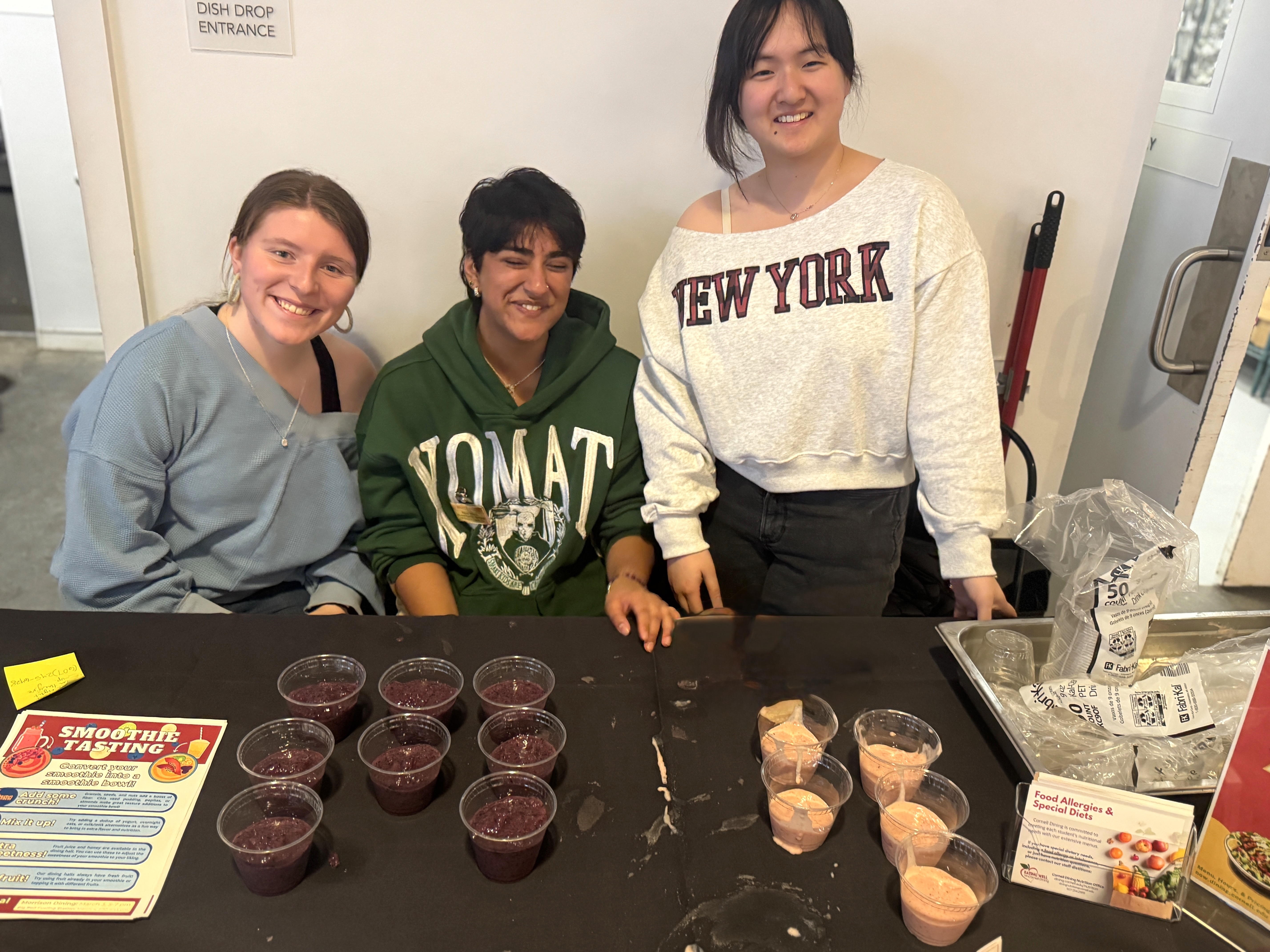 Students at a table with rows of smoothie sample cups