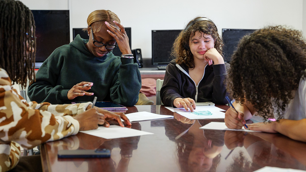 Students at Southside Community Center studying around a table