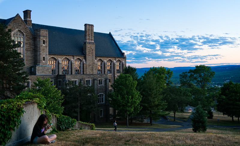 Image of Willard Straight Hall as the sun is setting behind it.