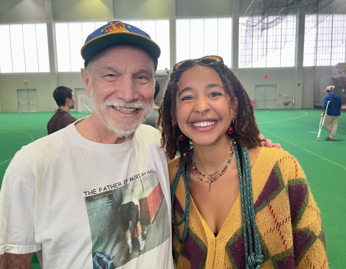 older gentleman with a mustache with a young lady with brown hair