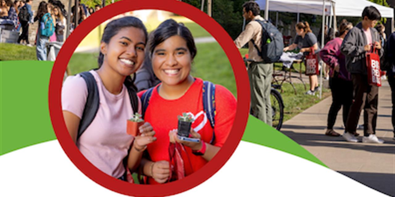 two girls with dark hair wearing backpacks and smiling with a background of people visiting the wellness fair