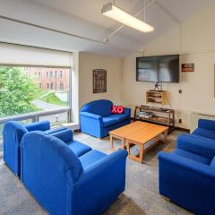 A large lounge in JAM with couches, tables, and a TV.