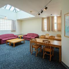 A lounge with couches, tables, and chairs.