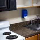 Low Rise kitchen with stove, sink, and empty cupboards