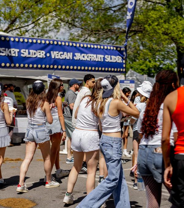 Students outdoors with a food tent in the background