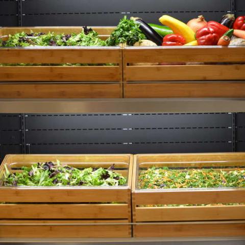 Bins of greens and vegetables