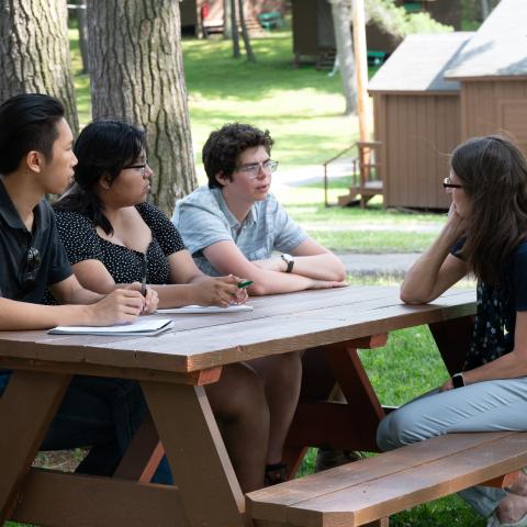 People sit at a picnic table