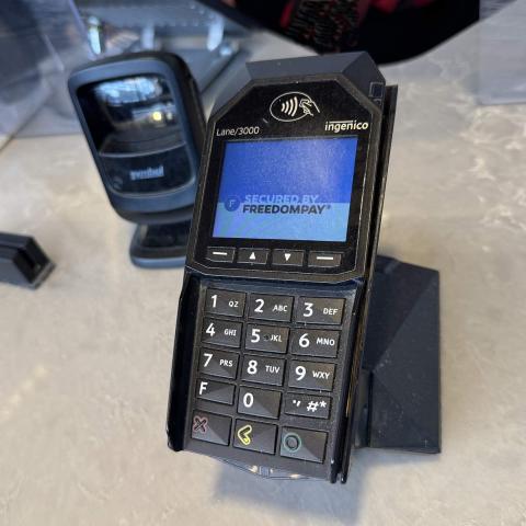 A payment terminal with card swipe and barcode scanner accessories