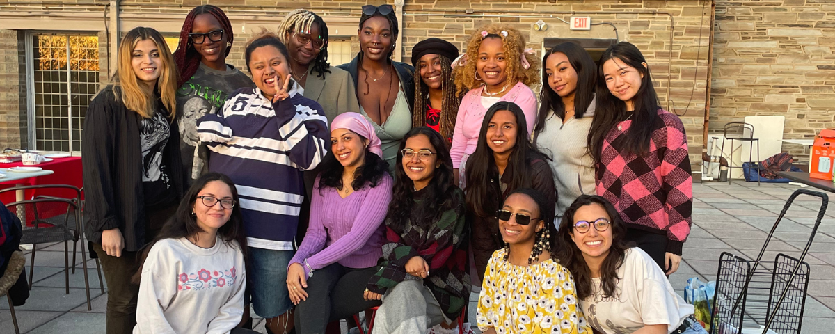 Women pose on a rooftop