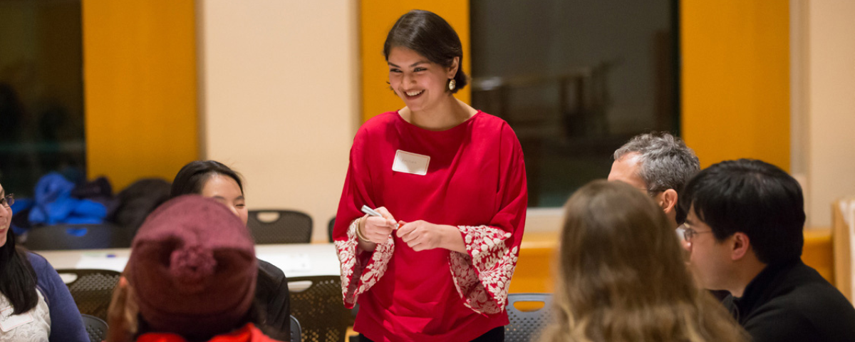 Woman talking to group of people.