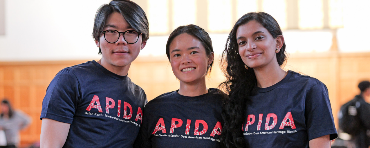 Three students post in shirts that say "APIDA"