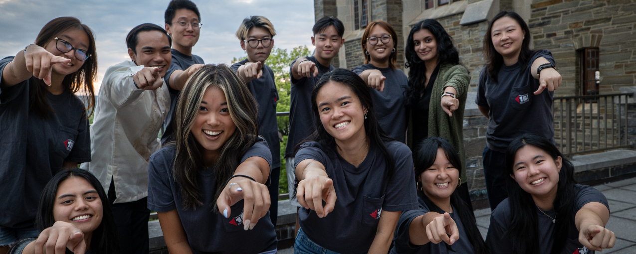 Students pointing at camera