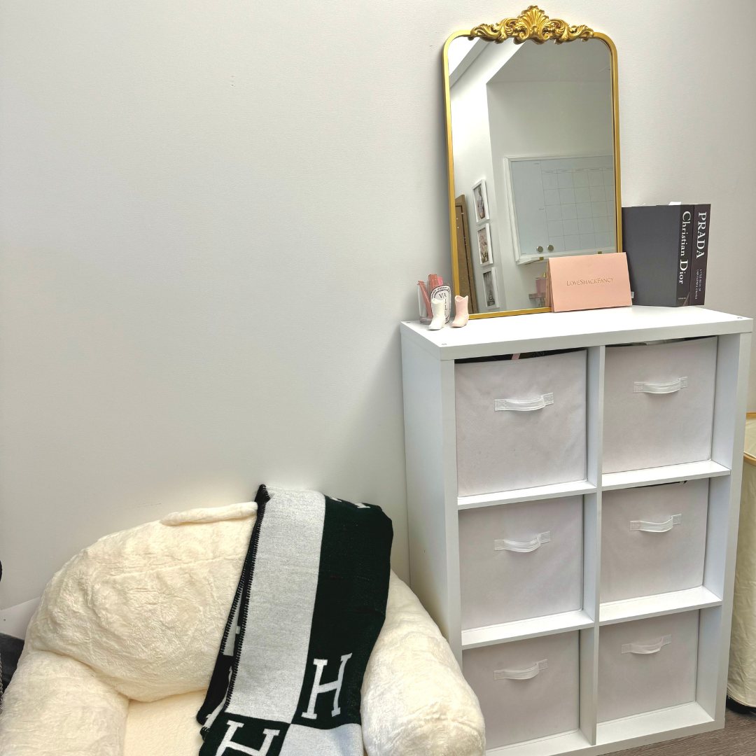 Chair, mirror sitting on top of a 6 drawer cabinet