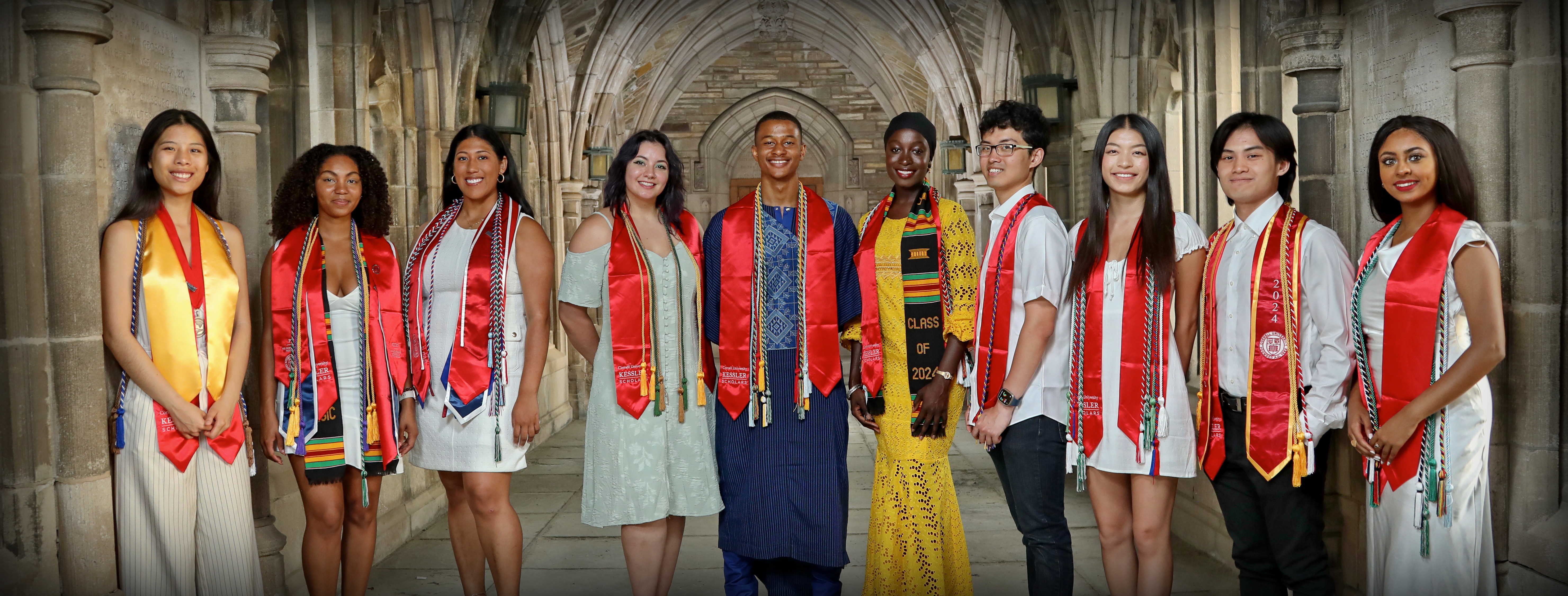 2023/24 Graduating Class of Kessler Scholars. Students lined up in a row wearing their chords and sashes
