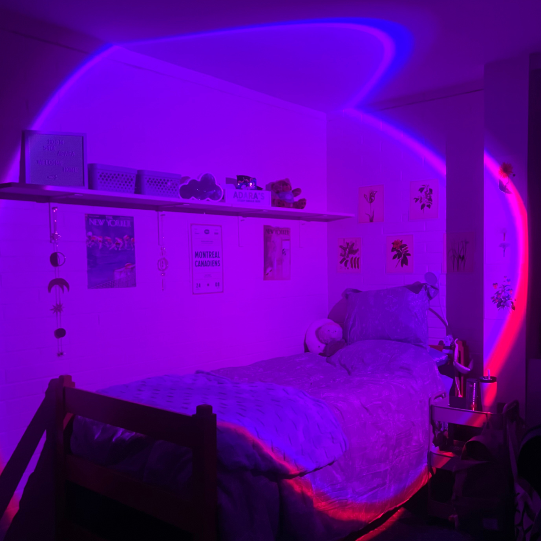 Student room picture, bed with blue linens and glow in dark lighting