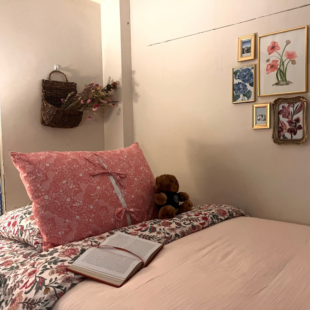 Bed with peach and floral linens