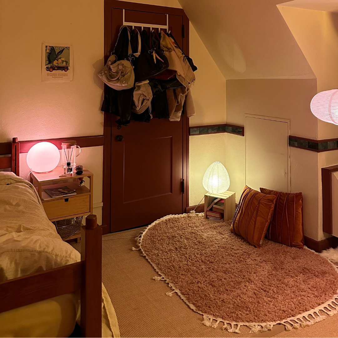 student room picture with rug and pillows on floor and accent lighting