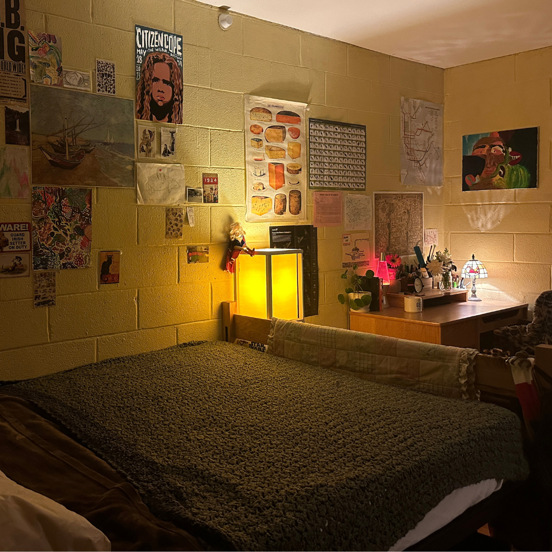 Bed, desk, and posters on wall