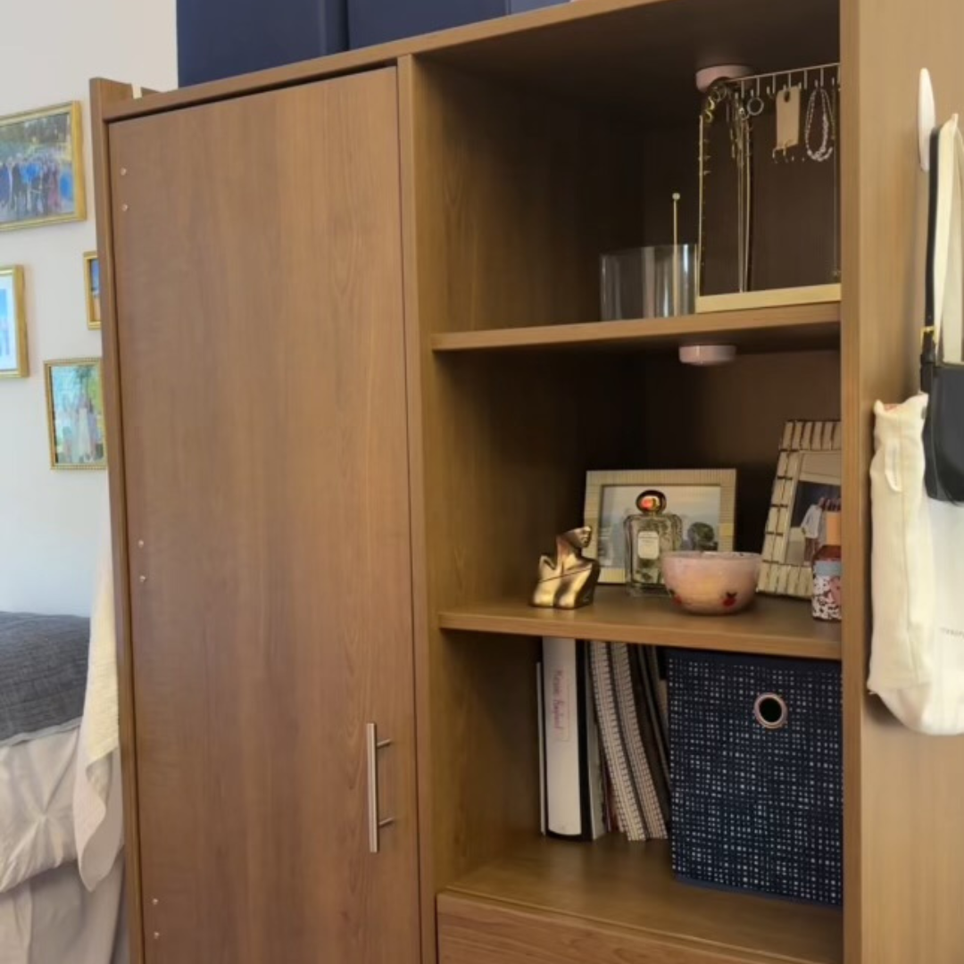 wardrobe with shelves containing books and photos