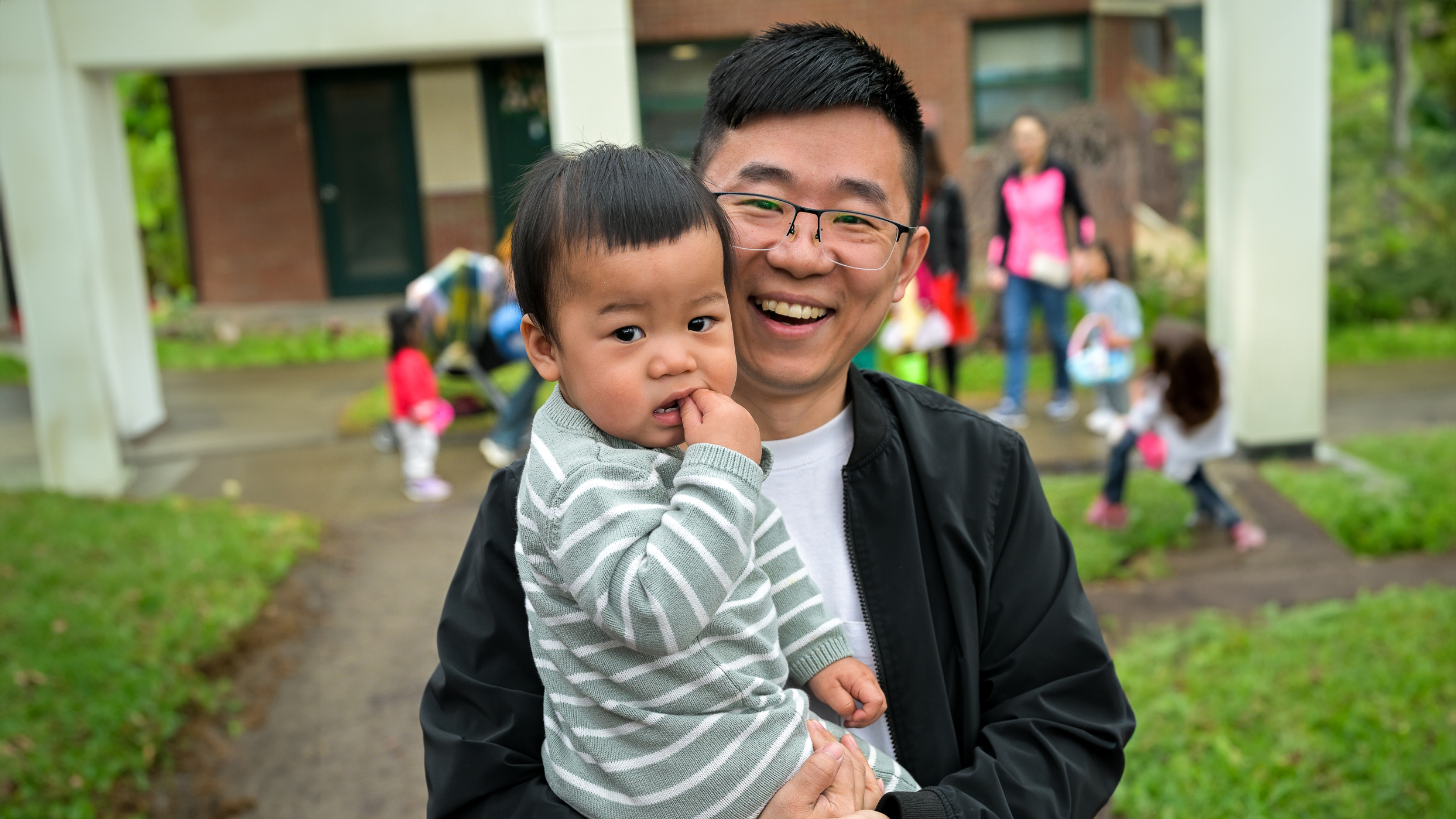Student holding their baby 
