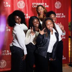 students in photo booth at willard straight hall centennial event