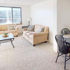 An apartment living room with dining table and hallway beyond